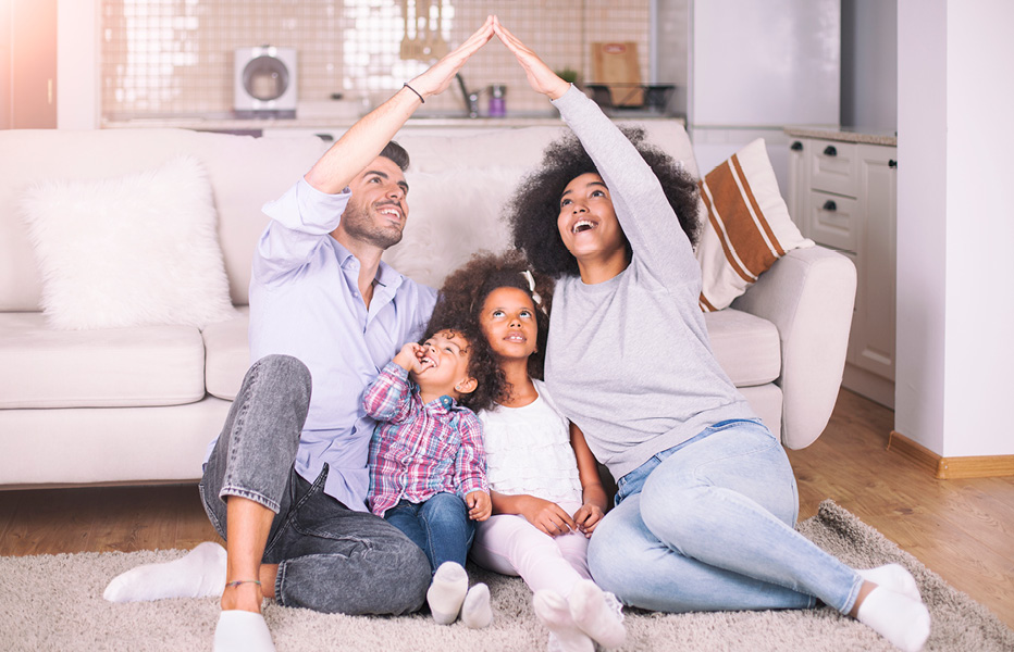 Family Sitting Together on Carpet in Living Room